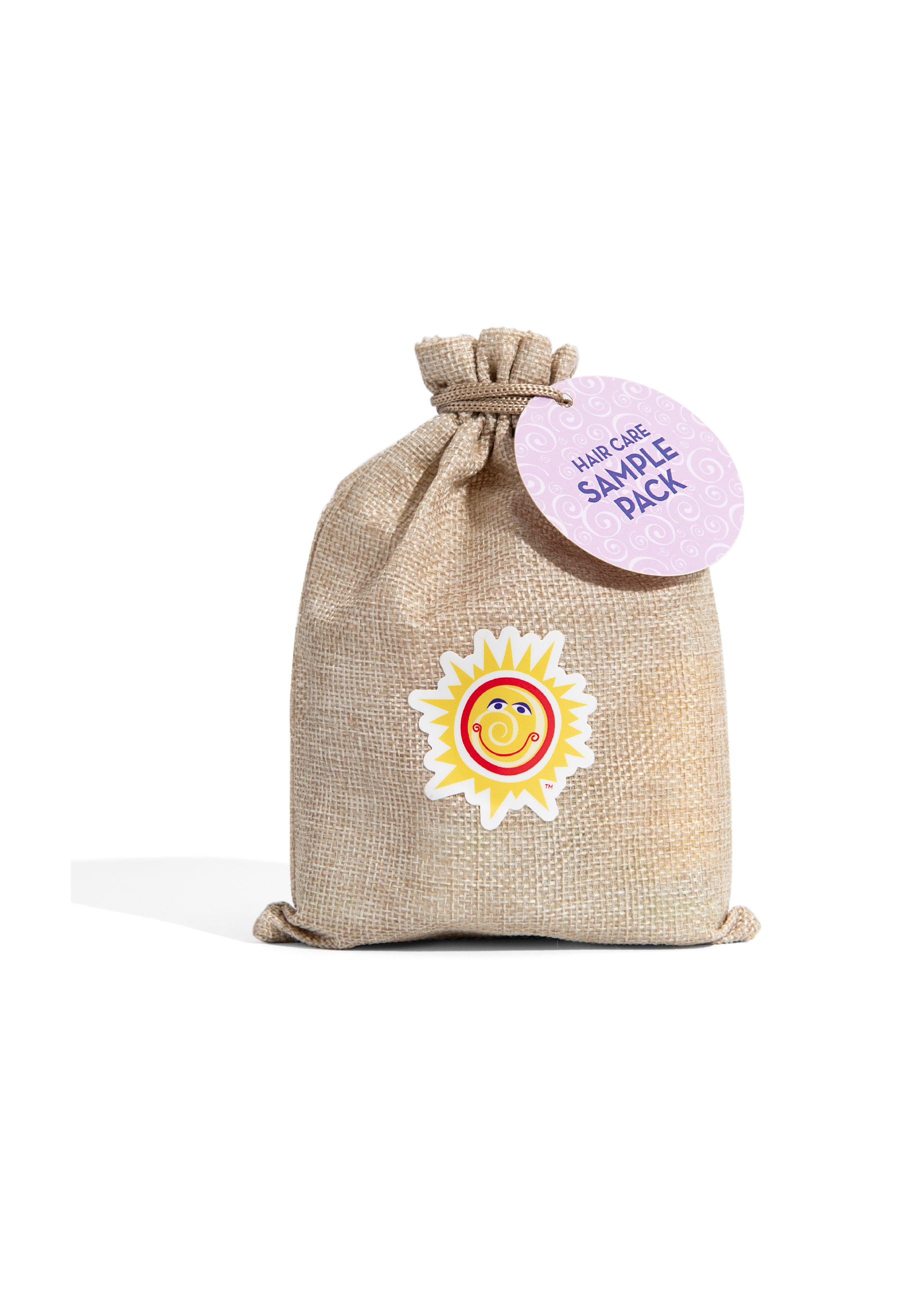 Natural jute drawstring bag with colorful sun logo and round tag labeled California Baby - Hair Care Sample Pack, perfect for baby shower gifts from a curated children’s boutique.