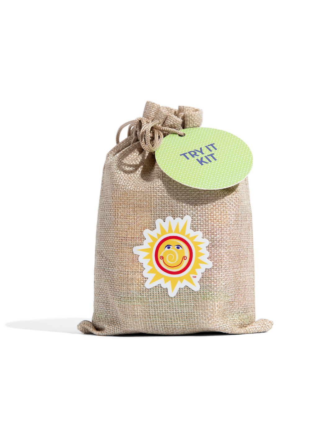 A beige drawstring pouch featuring a smiling sun logo and a green circular tag labeled California Baby - Try It Kit, representing a curated children’s boutique stylish essentials for little ones and moms.