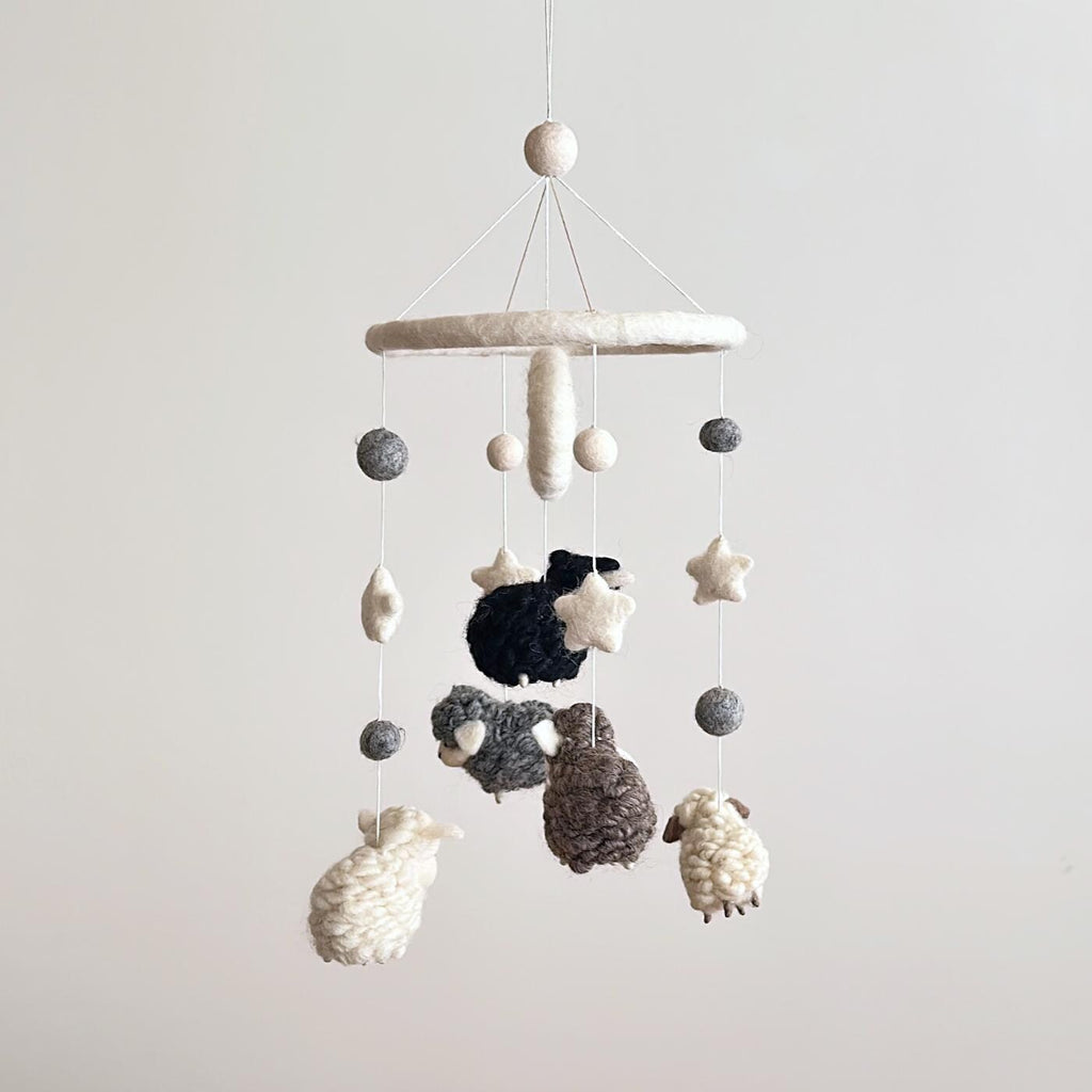 Mobile - Felt Baby Gray Sheep featuring soft felt sheep and star shapes in neutral tones, perfect for adding cozy charm to a nursery in a curated children’s boutique.