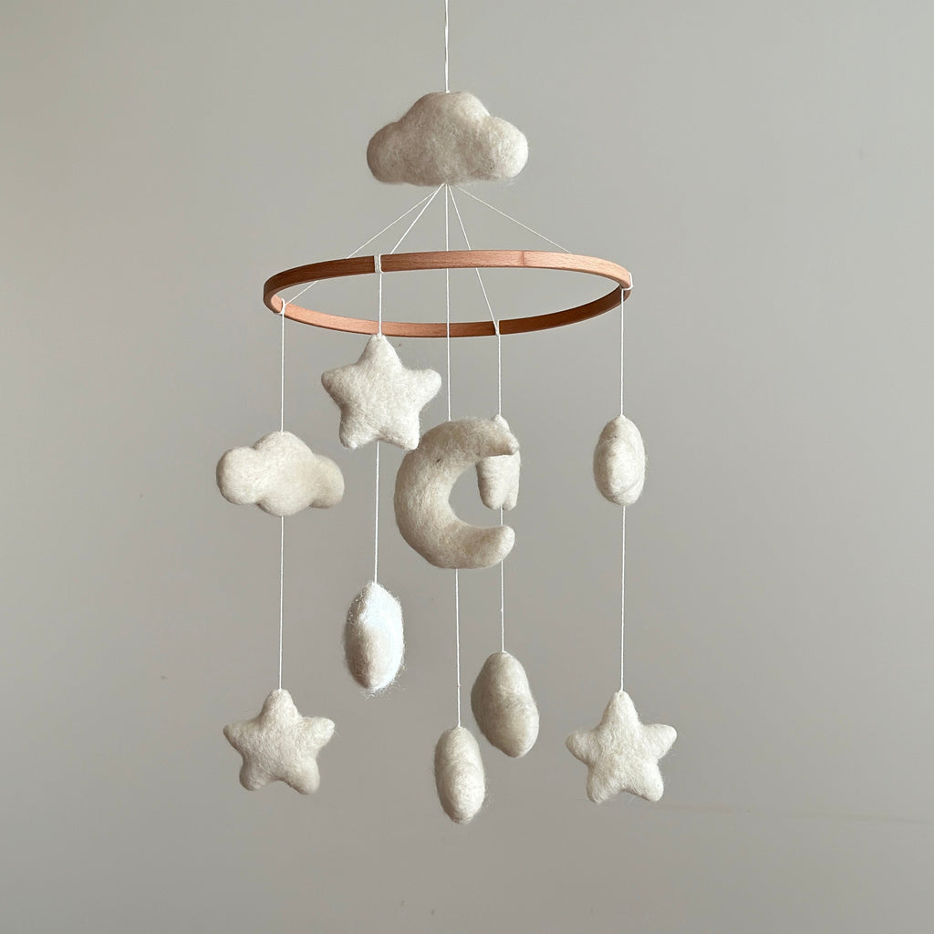 Mobile - Felt Baby - Moon & Stars hanging nursery decor with soft wool felt clouds, stars, and crescent moon in neutral tones, perfect for a cozy baby boutique setting.