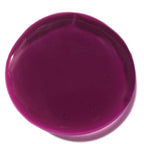 Swatch of deep berry-colored Natural Lip Oil (Limited-Edition) with a smooth, glossy texture reflecting light for a polished finish.