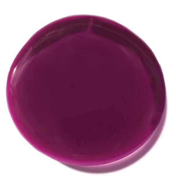 Swatch of deep berry-colored Natural Lip Oil (Limited-Edition) with a smooth, glossy texture reflecting light for a polished finish.