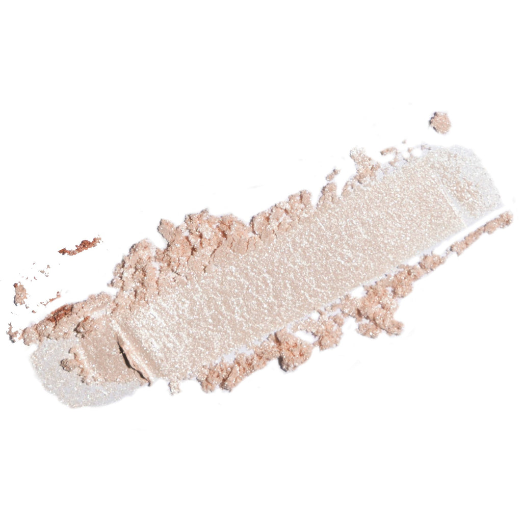 A textured smear of shimmering champagne-beige pressed powder, likely a cosmetic eyeshadow or bronzer, on a solid white background.