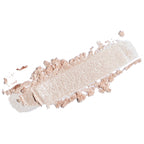 A textured smear of shimmering champagne-beige pressed powder, likely a cosmetic eyeshadow or bronzer, on a solid white background.