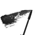 Close-up of a black mascara wand with a smooth, rich black swatch of Merle Norman Cosmetics - Supreme Lash Mascara, highlighting deep pigment and texture.