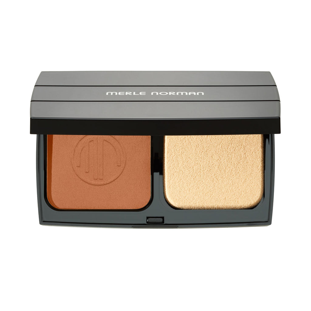 Merle Norman Cosmetics - Ultra Powder Foundation compact in a warm almond shade with an applicator sponge, designed for smooth, natural-looking coverage.